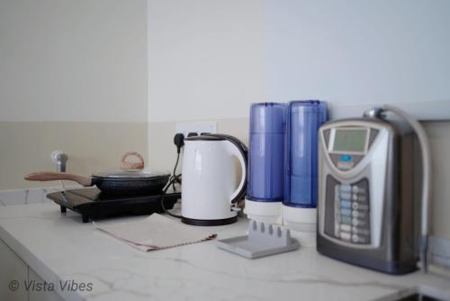 a kitchen counter with a phone and other items on it at Urban Suites Homestay by Vista Vibes in Jelutong