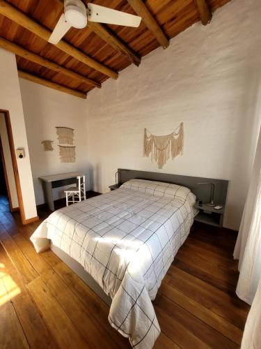 a bedroom with a bed and a table and a ceiling at Pindó III in Concordia