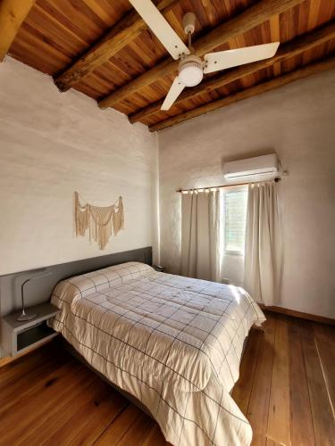 a bedroom with a bed and a ceiling fan at Pindó III in Concordia