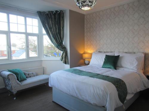 a bedroom with a large bed and a window at Captain Howey Hotel in New Romney