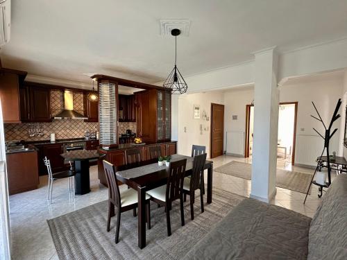 a kitchen and dining room with a table and chairs at Living Home Trikala in Tríkala