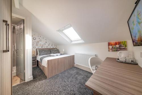 a small bedroom with a bed and a skylight at *RA12s* For your most relaxed & Cosy stay + Free Parking + Free Fast WiFi * in Headingley