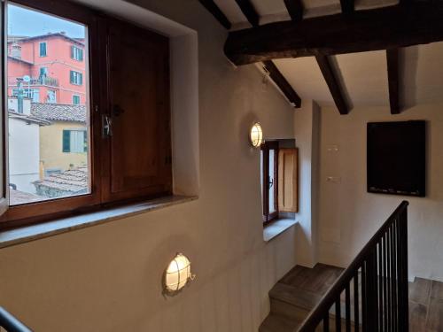 a staircase in a house with a window and a television at The Loft in Barga