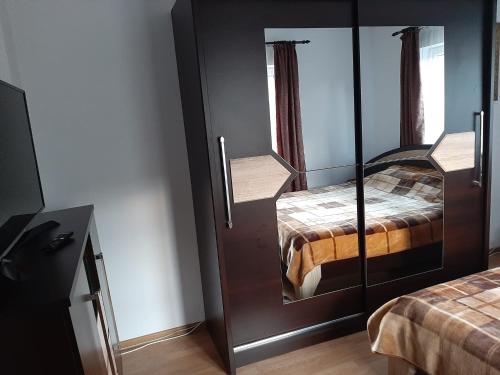 a room with two beds and a mirror at Casa Sofi in Vama