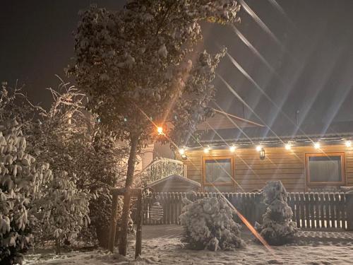 a house covered in snow at night with lights at FAIRVIEW FARM Holiday Accommodation 14 Luxury Lodges, Cabins, Dog Friendly, Suitable for Couples, Families and Groups, Wedding Guests , Corporate events, Sleeps 2-65 guests in Ravenshead, Nottingham near Sherwood Forest, set in 88 acres in Nottingham