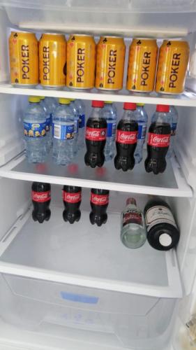 a refrigerator filled with bottles of soda and drinks at Heinz B. in Santa Ana de los Caballeros