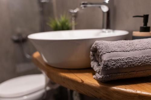 a bathroom with a white bowl sink and a toilet at Toma's House in Makrinítsa