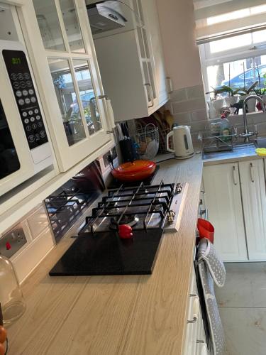 a kitchen with a stove and a counter top at Angels Pad in Dagenham