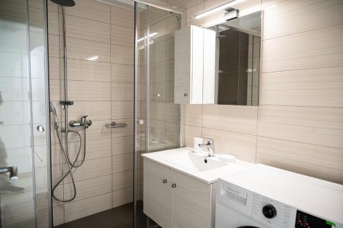 a bathroom with a sink and a shower at Elegant apartment with breathtaking cityscape view (Drap_F5) in Piraeus