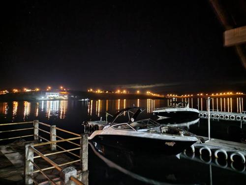 a couple of boats docked at a dock at night at Pousada do Lago Dutra in Guapé