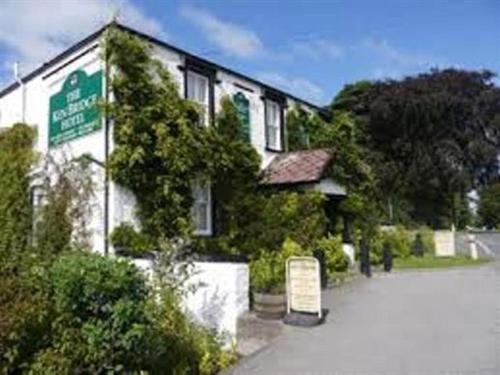 a building with a sign in front of it at The Ken Bridge Hotel in New Galloway