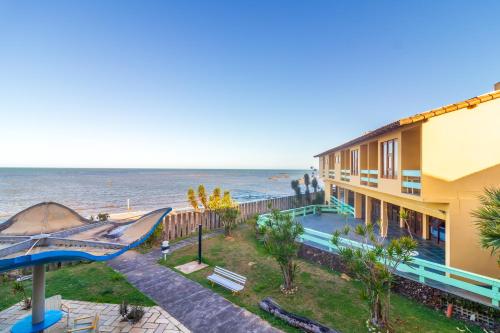 Praia Sol Hotel by Castelo Itaipava في سيرا: مبنى مطل على المحيط