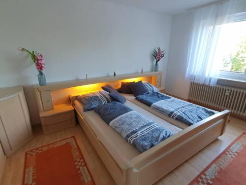 a bed with two pillows on it in a room at Ferienwohnung Ünal in Prien am Chiemsee