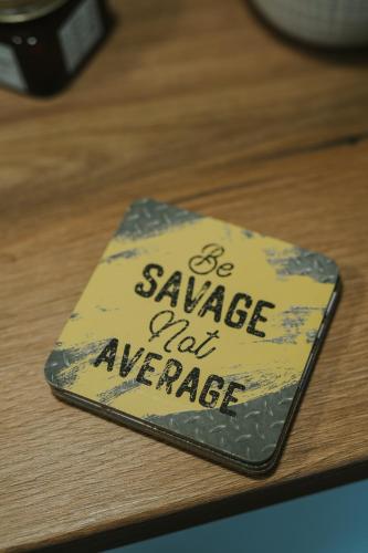 a sign that says be savage and average on a table at Apartment My Choice in Sarajevo