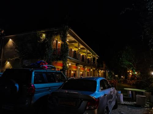 a police car parked in front of a house at night at JMT Eco-Binsar by StayApart in Panuānaula