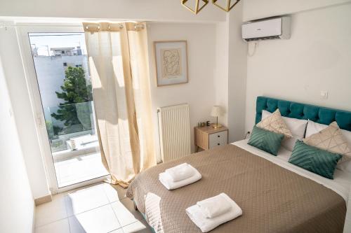 a bedroom with a large bed and a large window at Elegant apartment with breathtaking cityscape view (Drap_F5) in Piraeus