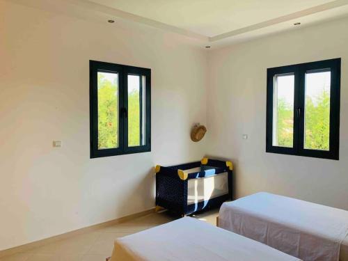 Habitación con 2 camas y 2 ventanas. en Villa climatisée avec piscine sans vis-à-vis, en Essaouira