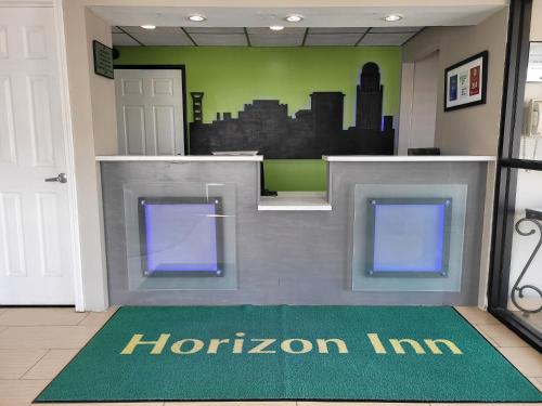 a houston inn lobby with a houston exit rug at Horizon Inn in Lincoln