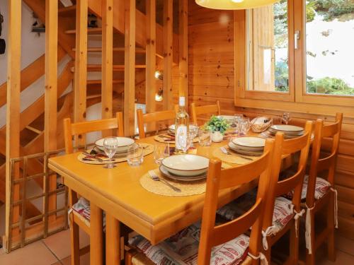 a dining room with a wooden table and chairs at Chalet Gamine by Interhome in Veysonnaz