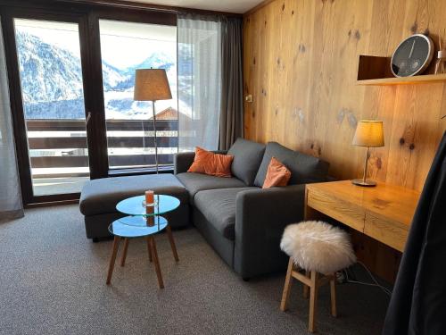a living room with a couch and a table at Apartment Utoring Acletta-48 by Interhome in Disentis