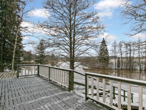 a bridge over a river with a tree at Holiday Home Rajamaja by Interhome in Palikainen