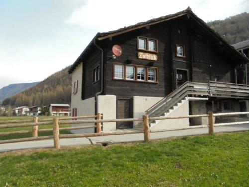 a building with a sign on the front of it at Apartment Talblick by Interhome in Saas-Grund