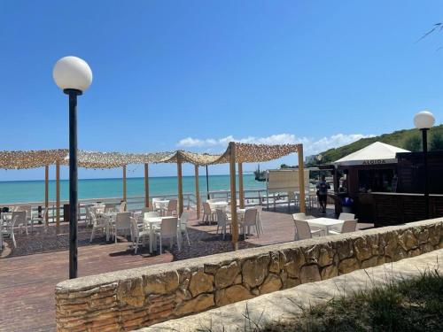 un ristorante con tavoli e sedie sulla spiaggia di Holiday Home Internazionale Manacore by Interhome a Peschici