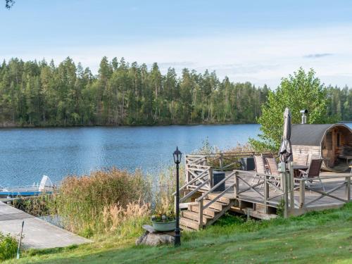 a cabin on a dock next to a lake at Chalet Toltorp - SDM100 by Interhome in Katrineholm