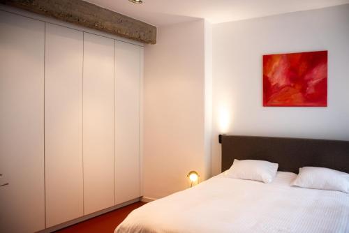 a bedroom with a bed and a large closet at The Industria - Stylish in Historical Center in Antwerp