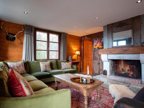 a living room with a couch and a fireplace at Chalet Chalet Tetras by Interhome in Chesières