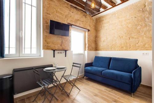 a living room with a blue couch and a table at Superb apartment- 4P- Montorgueil Nazareth in Paris
