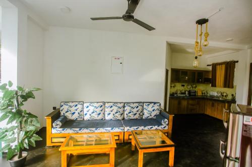 a living room with a couch and two tables at Little Angels in Mirissa