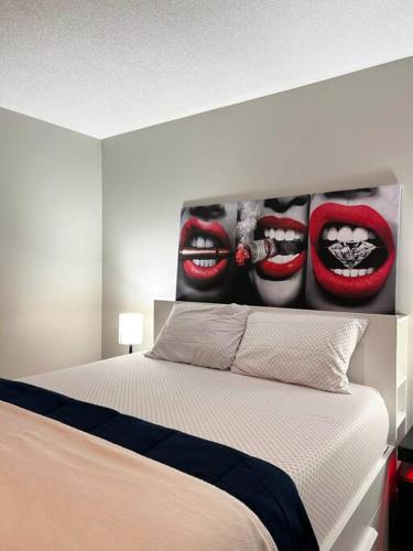 a bedroom with a bed with a painting of lips at Room in Oshawa, 24/7 Security, Free Parking in Oshawa