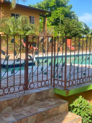 a fence in front of a swimming pool at Montego Bay, Ironshore Luxury Studio in Montego Bay