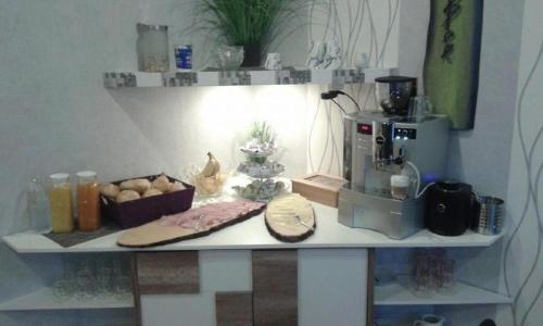 a kitchen counter with a mixer and a cutting board at Pension Hedy in Bad Schallerbach
