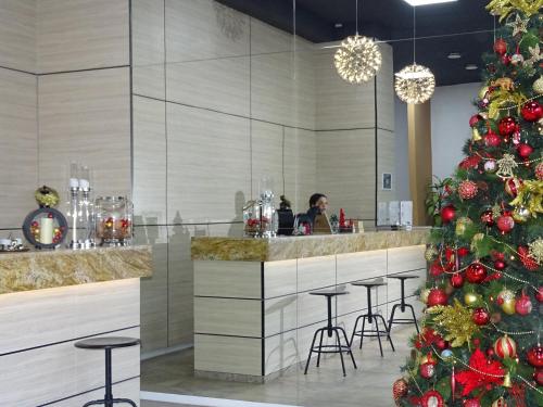 a christmas tree in a restaurant with a bar at 4Guest Hotel in Yerevan