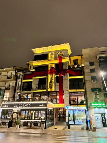 a large building with a red ribbon on it at Alo Alo Apartman 4 in Kruševac