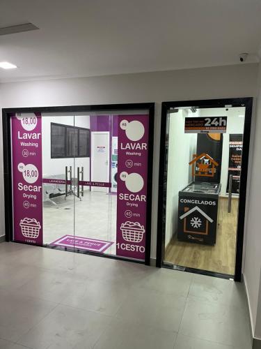a store with three glass doors in a room at Apartamento com vista da praia da Costa 615 in Vila Velha