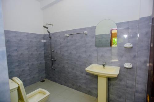 a bathroom with a sink and a shower at Little Angels in Mirissa