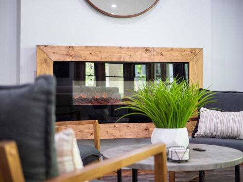 a living room with a table with a potted plant at Welcome To Wine Country - Relaxed Luxury in Geneva