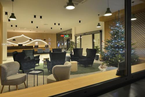 a christmas tree in the lobby of a store at Hotel Element in Lipno nad Vltavou