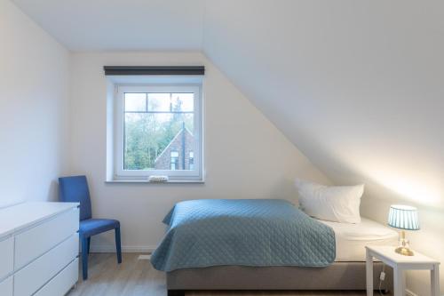 a bedroom with a bed and a window at Kleine Flucht in Tating