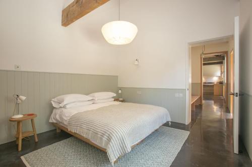 a bedroom with a bed with white sheets and a lamp at Lookout in Dorchester