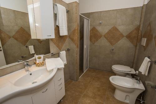a bathroom with a sink and a toilet at Agriturismo Tenuta Don Giovanni in Melendugno
