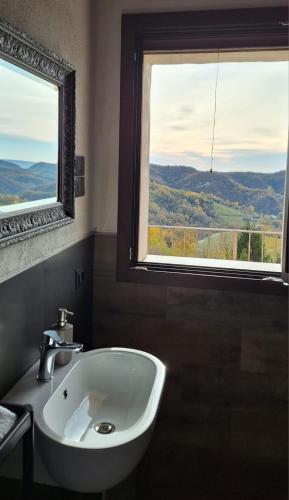 a bathroom with a sink and a window with a view at Agriturismo La Pina in Tarzo