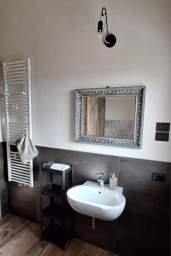 a bathroom with a sink and a mirror on the wall at Agriturismo La Pina in Tarzo