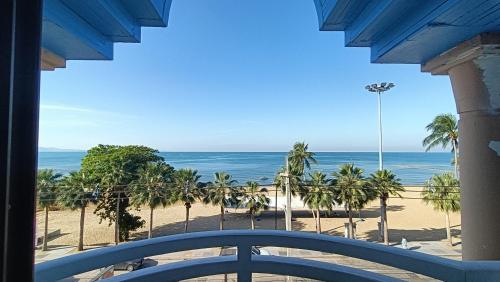 a view of the beach from the balcony of a resort at Boho Rent A room in Jomtien Beach