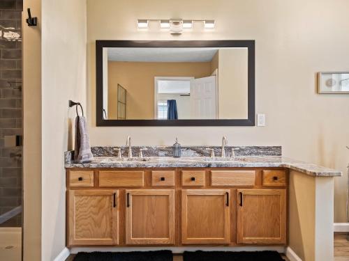 a bathroom with a sink and a mirror at Steps to CLE Clinic - Great for Families - ADA in Cleveland