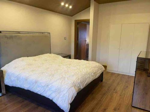 a bedroom with a bed and a wooden floor at Horizon Villa in Amman