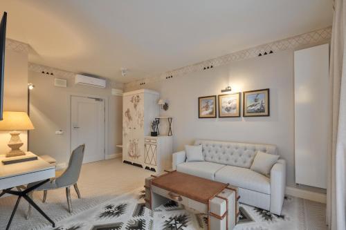 a living room with a couch and a table at Aries Hotel & SPA Szczyrk in Szczyrk
